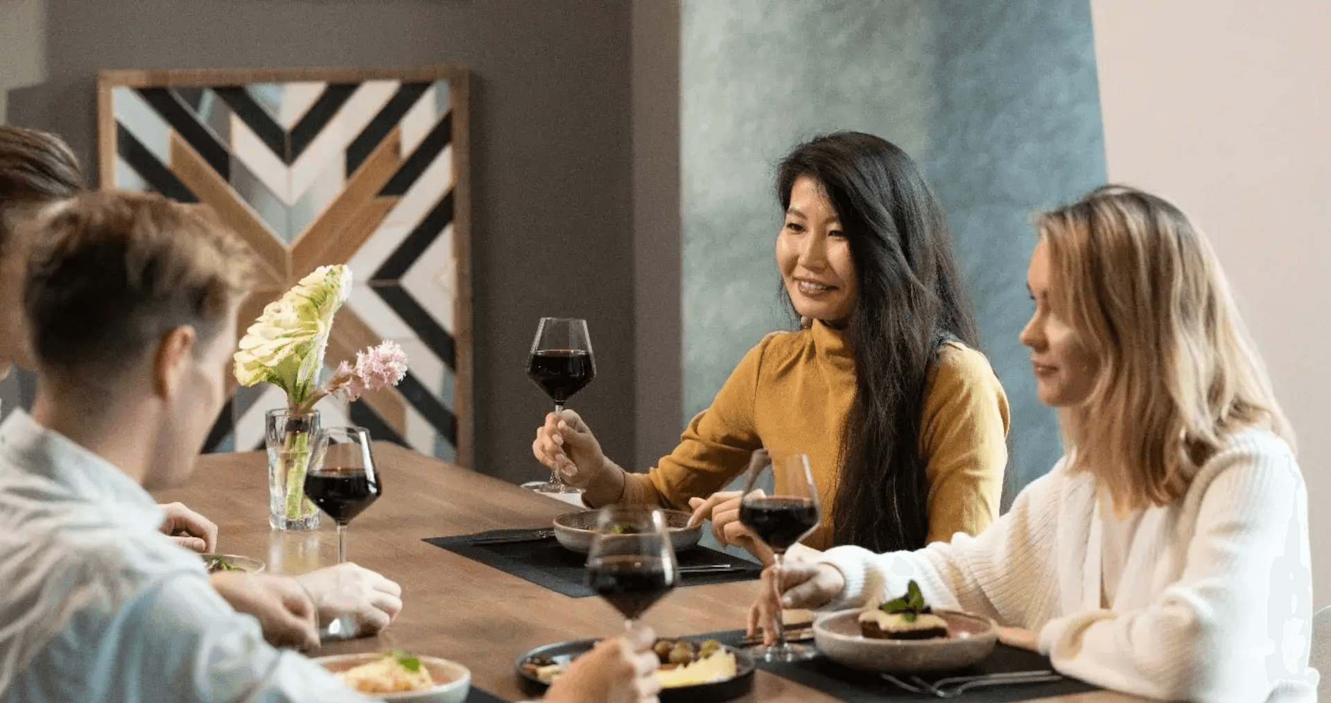 People enjoying a glass of wine discussing the rise of luxury co-living spaces