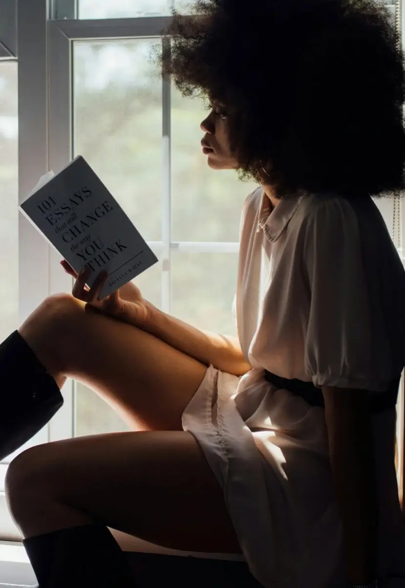 Woman reading a book in her studio in Manchester