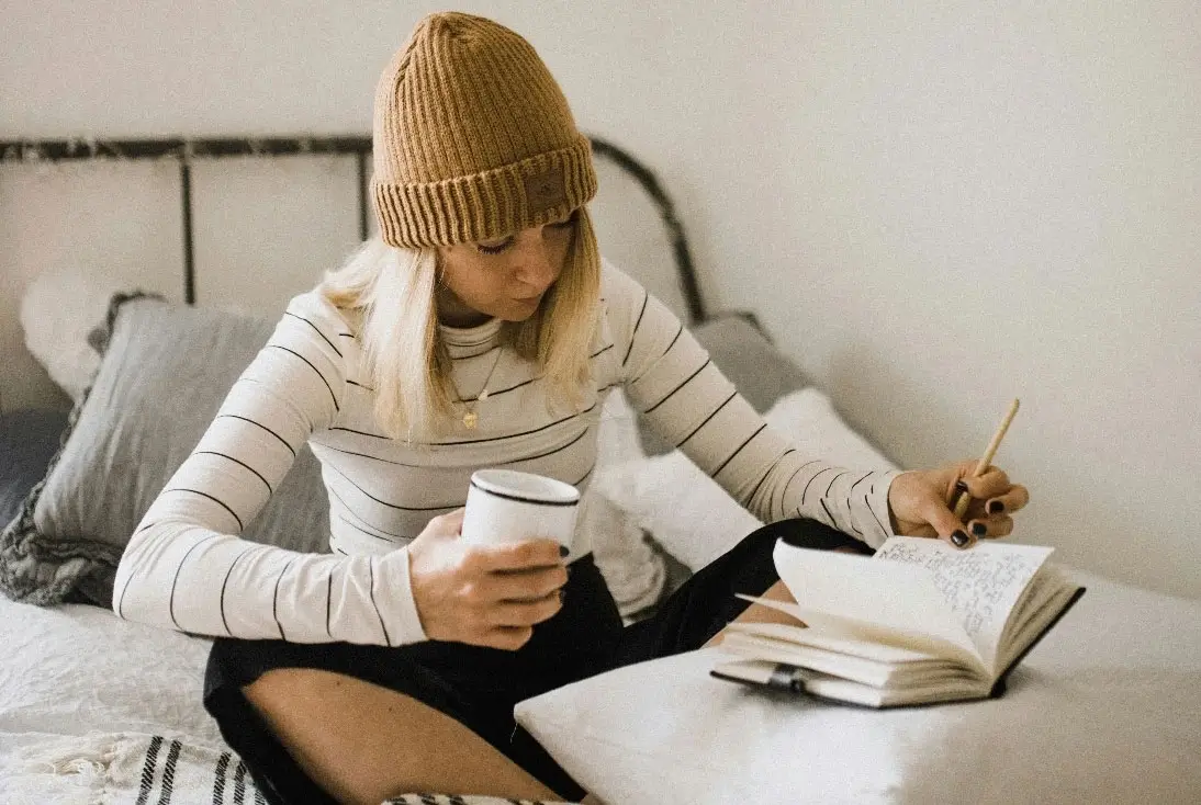 Student reading a book in her studio in Manchester